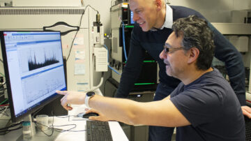 Professor Justin Walley (standing) and Research Scientist Christian Montes review data from their research to better understand the contents of plant cells. (Photo by Whitney Baxter, Iowa State University)