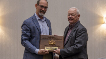 Larry Richardson receives the Outstanding Achievement in Sorghum Improvement Award from Tim Lust.
