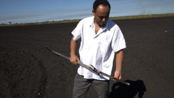 Niguss Solomon Hailegnaw, UF/IFAS EREC assistant professor and Everglades Soil Testing Lab director, examines muck soil in the Everglades Agricultural Area. (Avery Harrison/ UF/IFAS EREC)