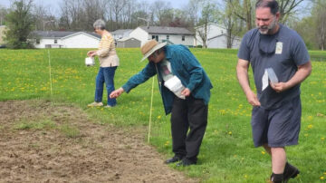 Volunteers and community members help Greg Kedzierski (far right) spread native seed at planting site. (Amber Stilwell, Penn State Extension)
