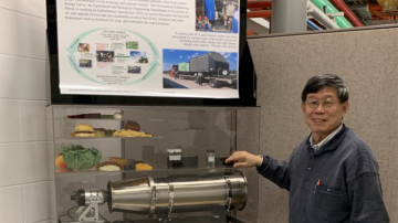 Yuanhui Zhang with a model of a biowaste recycling project.