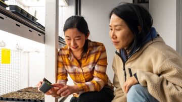 Associate professor Gyeong Mee Yoon, and PhD candidate Yuan-Chi Chien, both in the department of botany and plant pathology, observe a young Arabidopsis plant in a growth chamber at Purdue University. (Purdue University/Joshua Clark)