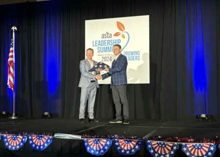 Dan Foor, right, hands Dave Armstrong a flag that was flown over the U.S. Capitol in his honor.