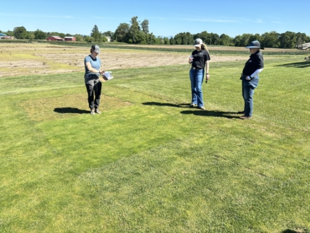 From left, DLF Research Assistant Caelin Johnson talks with Susanna Sieke and Leah Brilman about the research that was conducted to develop the new 4Most™ seed enhancement.