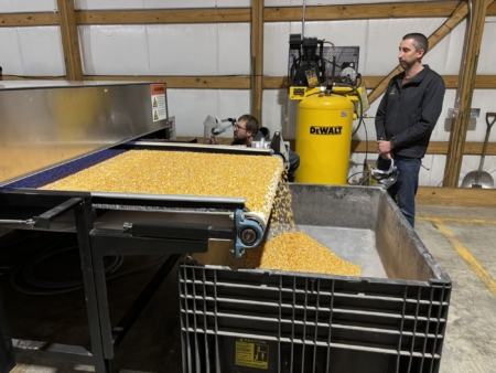 Jason Phillips, right, shows how light is used to activate seed traits.