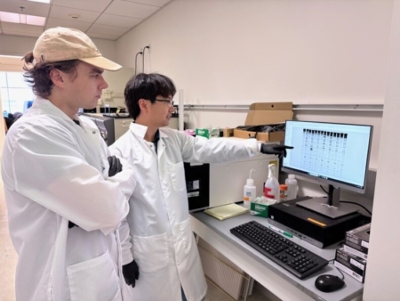 Co-first authors Kevin Wasko (left) and Honglue Shi in front of their gel imager, confirming that the SpRY Cas9 variant struggles to effectively open DNA.