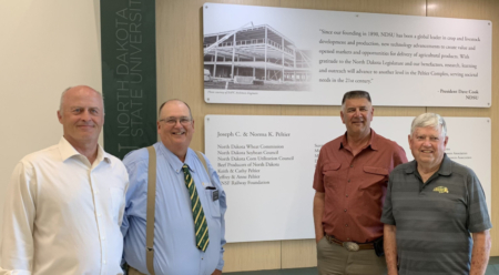 USW Secretary-Treasurer Jim Pellman; NDWC Board Member Jim Bahm; Past NDWC Chairman Greg Svenningsen; and past NDWC Chairman David Clough at the dedication of the Peltier Complex on the campus of North Dakota State University.