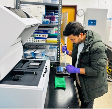Kamal Chhetri loads a DNA library into a nanopore sequencing platform in the Zeng Lab at Southern Piedmont Agricultural Research and Extension Center. (Photo by Ayodeji Bello)