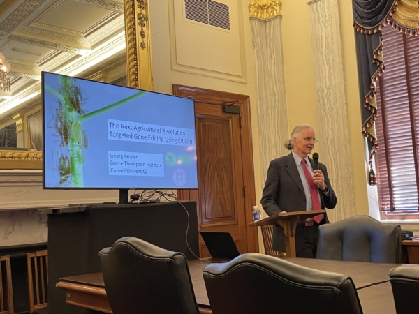 Georg Jander addresses an audience in the offices of the U.S. Senate Committee on Agriculture, Nutrition, and Forestry.