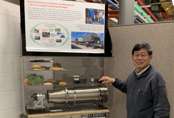 Yuanhui Zhang with a model of a biowaste recycling project.