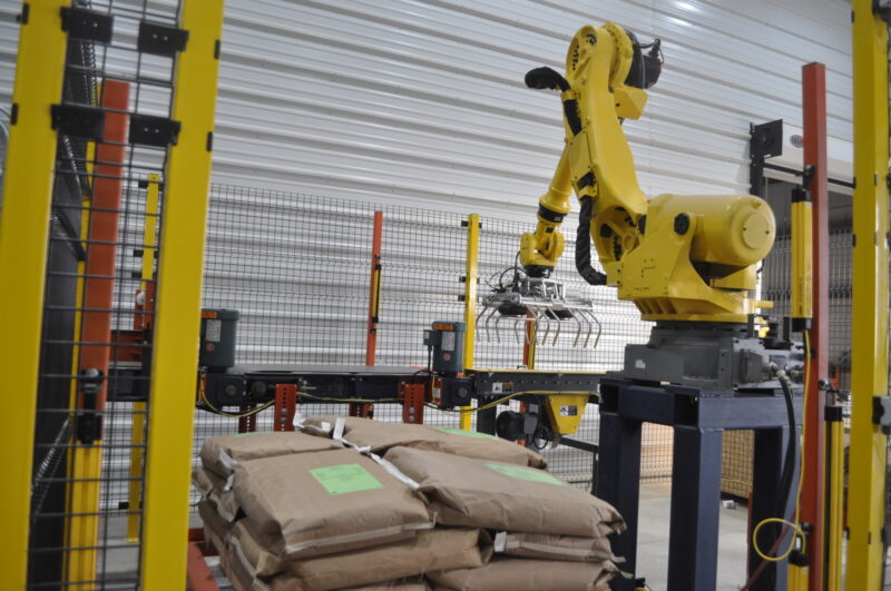 JEM robotic palletizer stacks filled bags coming off the JEM bagging line.