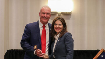 Leigh Ann Sayen (right) passes the gavel to newly installed AFIA Board Chair Dan Meagher (left).