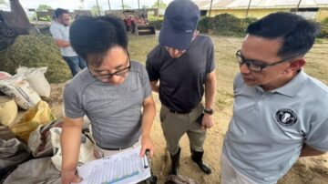 The U.S. Grains & BioProducts Council's (USGBC's) regional office for Southeast Asia & Oceania (SEA&O) is working to help expand the region's dairy sector through training and nutritional advancements. Pictured, USGBC Consultant Dr. Walter Chen (left) and USGBC Consultant Dr. Todd Meyer (middle) discuss feed formulations at a dairy farm in Maramag, Philippines. Image courtesy of the U.S. Grain and BioProducts Council.