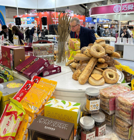 North Dakota farmer Don Hardy examines the variety of food products made with U.S. Wheat at the Hong Ming Corporation Booth at the 2026 Taiwan International Baking Show. Photo credit: USW.