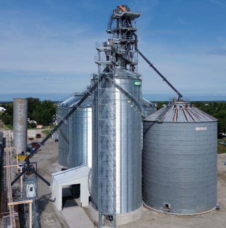 Among four new AGI steel bins is an old, 60-foot Behlen bin that survived the 2023 derecho.