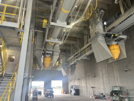 The truck system operates on a track and load while moving, reducing repositioning and improving turnaround time.