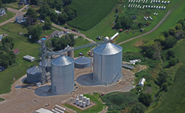 Two new Behlen tanks (center) are rated at 365,000 and 605,000 bushels, respectively, at 21st Century Cooperative in Cumberland, IA. Aerial photo by JH photography, Spencer, IA.