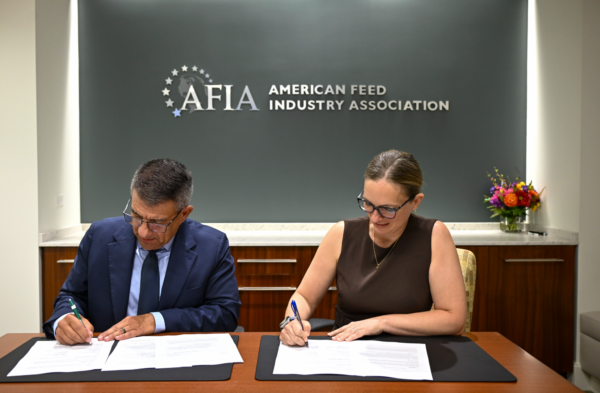 GEAPS Chief Executive Officer John Caupert, left, and AFIA Chief Operating Officer Megan Provost, right, sign a memorandum of understanding expanding educational and professional development opportunities for members of both organizations. Photo credit: Grain Elevator and Processing Society.