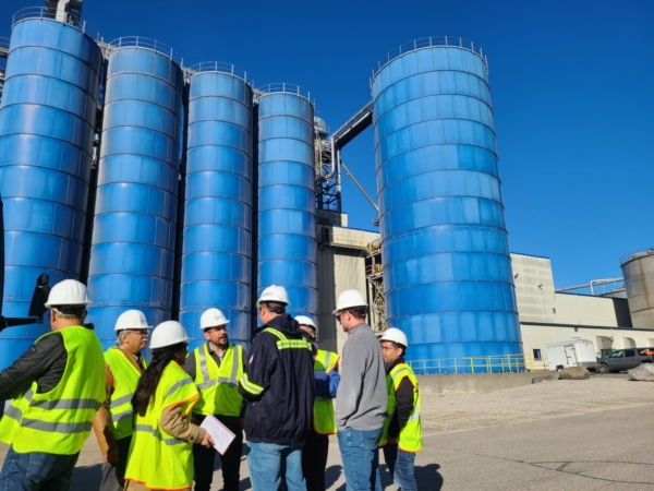 Last week, a Global Ethanol Summit (GES) post-team of Mexican researchers, government officials and industry stakeholders visited Wisconsin to view the U.S. bioethanol value chain. Pictured, team members discuss the ethanol fermenting process at Azatlan Bio. Image courtesy of USGBC.