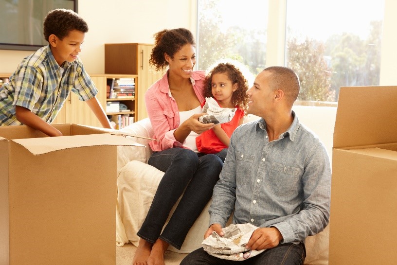 Family packing up boxes to move into a new home