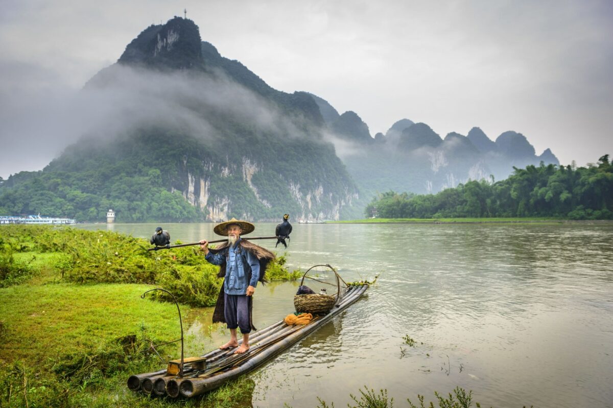 China Yangshuo ormorant fisherman and his birds on the Li River