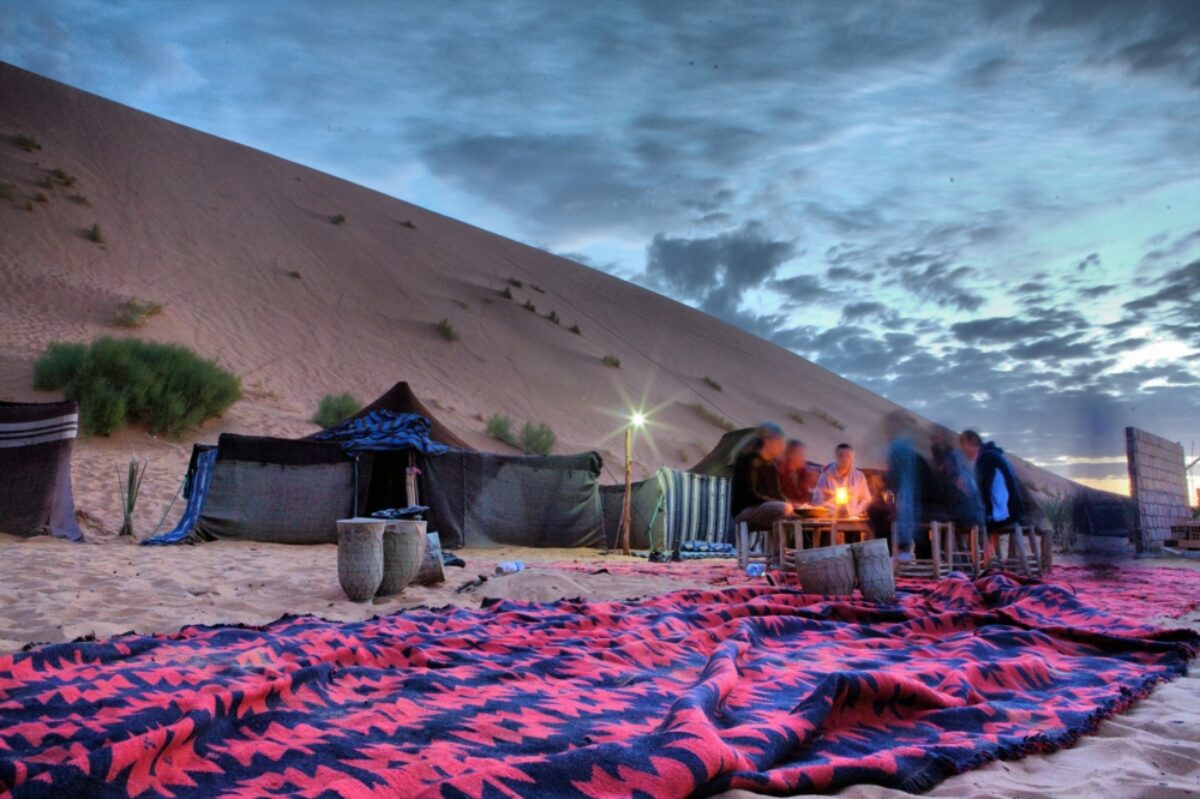 Morocco Merzouga Tourists resting around the campfire