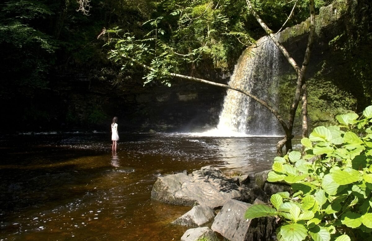 Family Sgwd Gwladus or Lady Falls on the River Pyrddin in the Brecon Beacons National Park UK