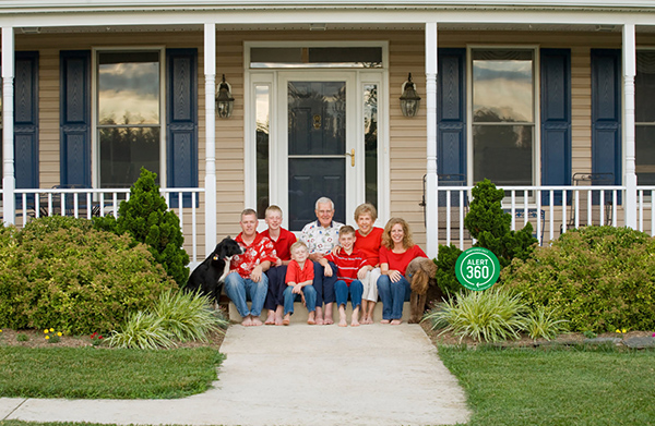 Alert 360 security protecting family sitting outside house.
