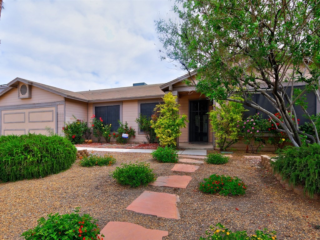 18134 PEACHES - APRICOTS AND GRAPEVINES OUTSIDE. UPGRADED CABINETS - CORIAN COUNTER TOPS - STAINLESS STEEL APPLIANCES AND TILE FLOORING THROUGHOUT ON THE INSIDE. THESE ARE JUST SOME OF THE PLUSES THIS ADORABLE HOME HAS TO OFFER. ONE STORY FOR EASY ENTRY. SOLAR SCREENS AND DUAL PANE WINDOWS FOR LOW UTILITY BILLS. BALANCED POWER. THE TWO CAR GARAGE - WITH IN-WALL COOLING AND HEATING - IS BEING ENJOYED AS AN ADDITIONAL FAMILY ROOM.