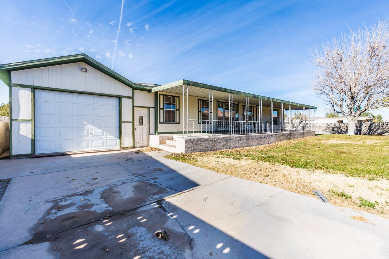 1248 sq ft. Manufactured home and detached garage convey with land. 2 Bedrooms, 2 bathrooms, and a Den. Great front yard with a covered patio and Mountain Views! Sold AS-IS!