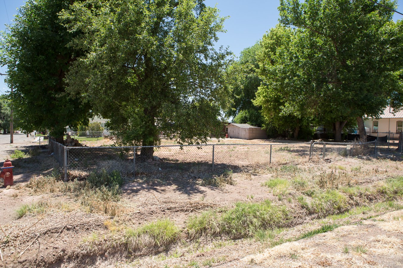 Great corner lot with mature trees and storage shed. Impact fee have been paid previously. All utilities believed to be stubbed to the property. Buyer/Buyers agent to verify.