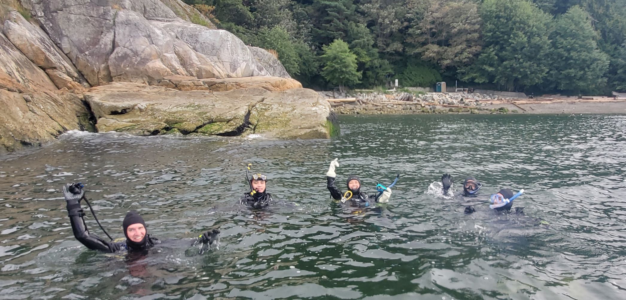 Divers swimming back near the wall after a great dive at Whytecliff Park
