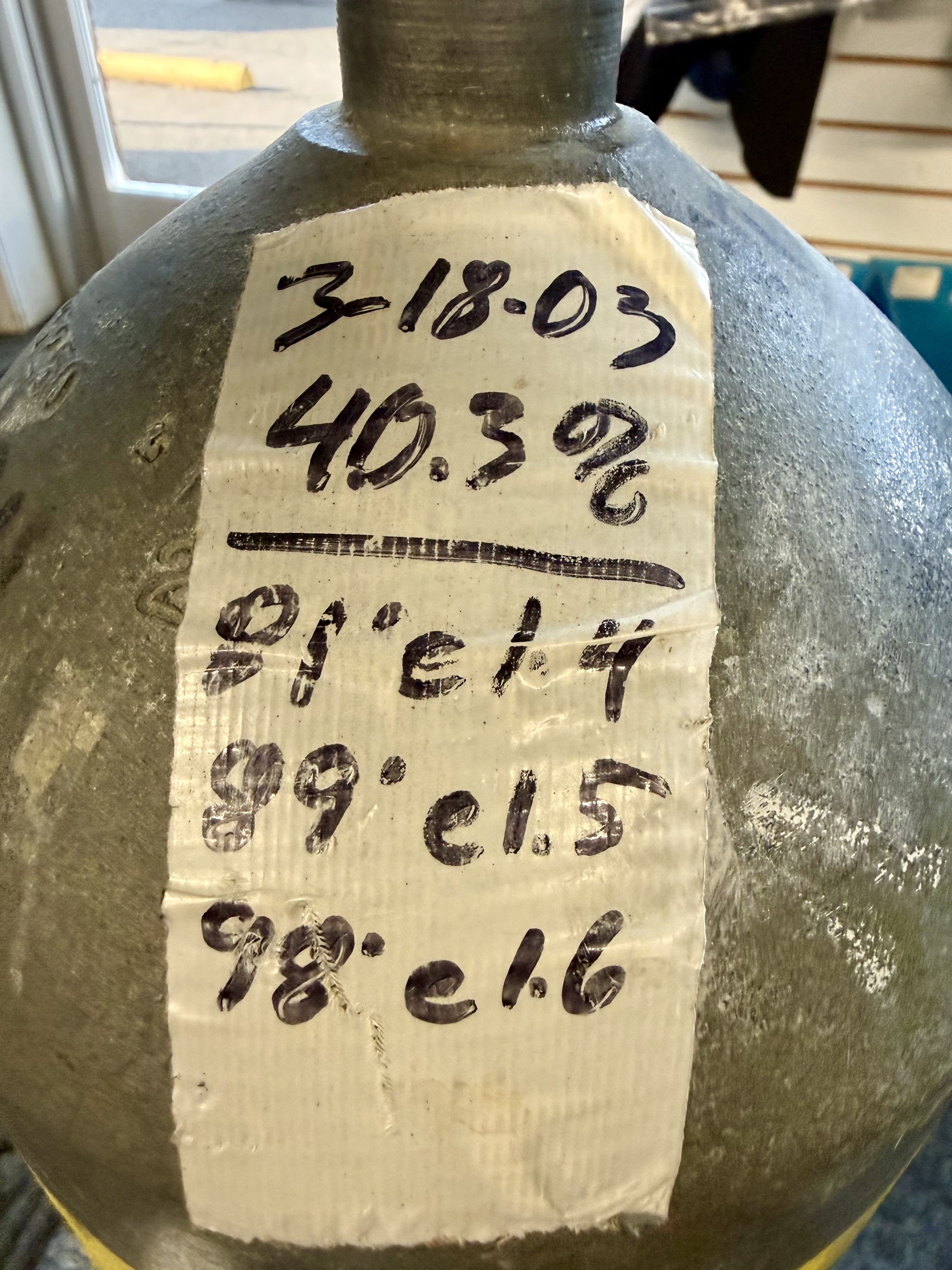 Handwritten nitrox analysis label on an old cylinder