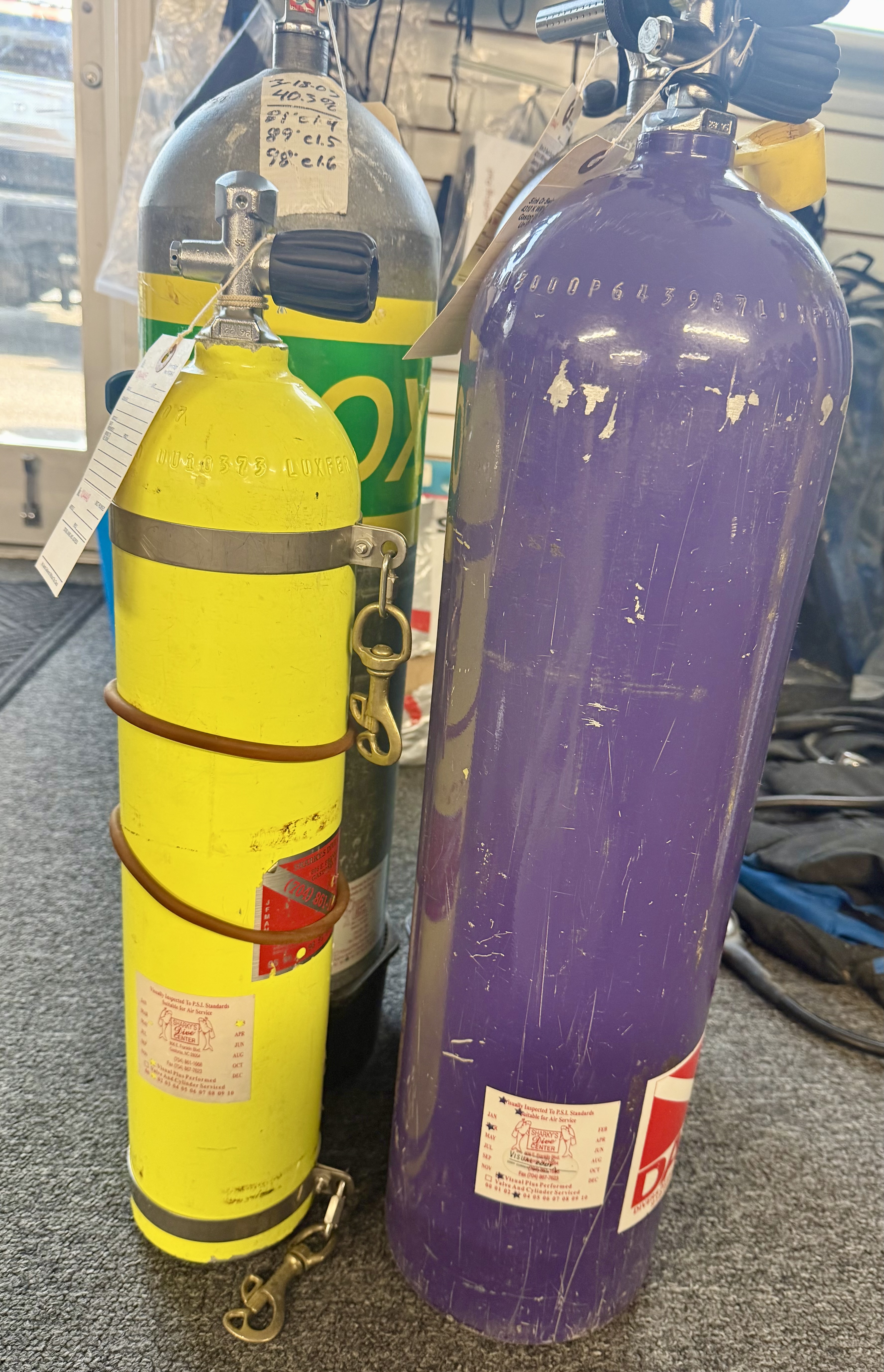 Vintage scuba cylinders with original visual-inspection labels