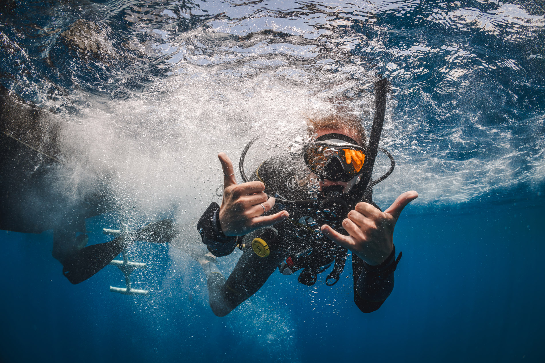 Divers exploring clear blue water