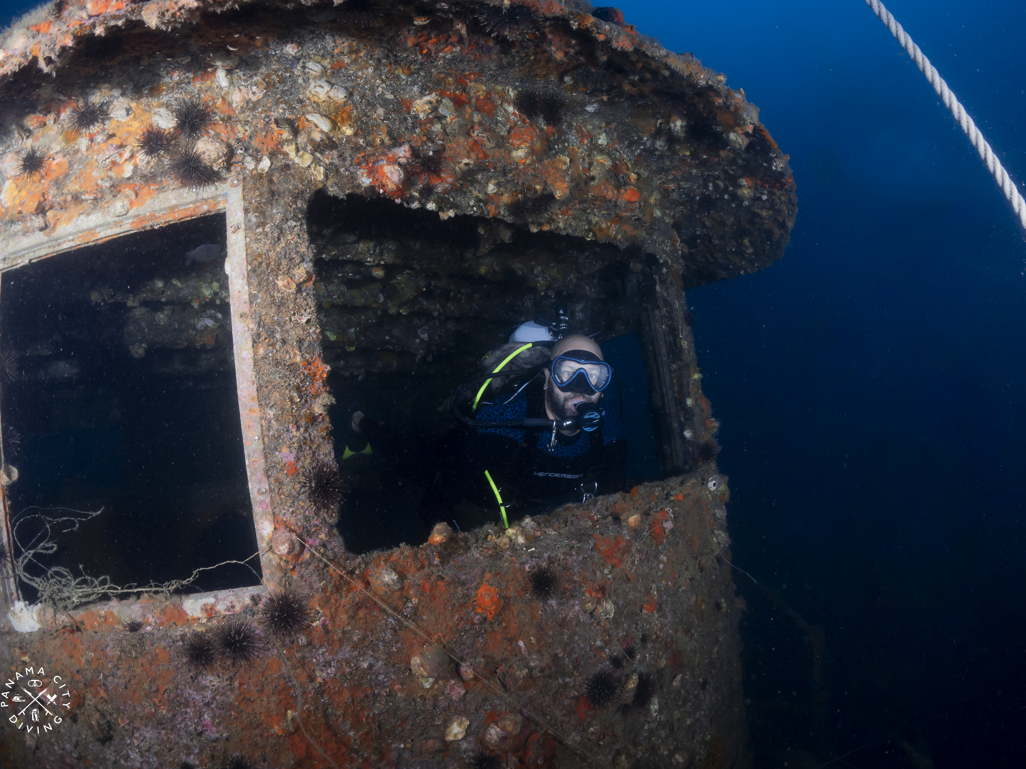 A diver explores the wheelhouse of the top tug 