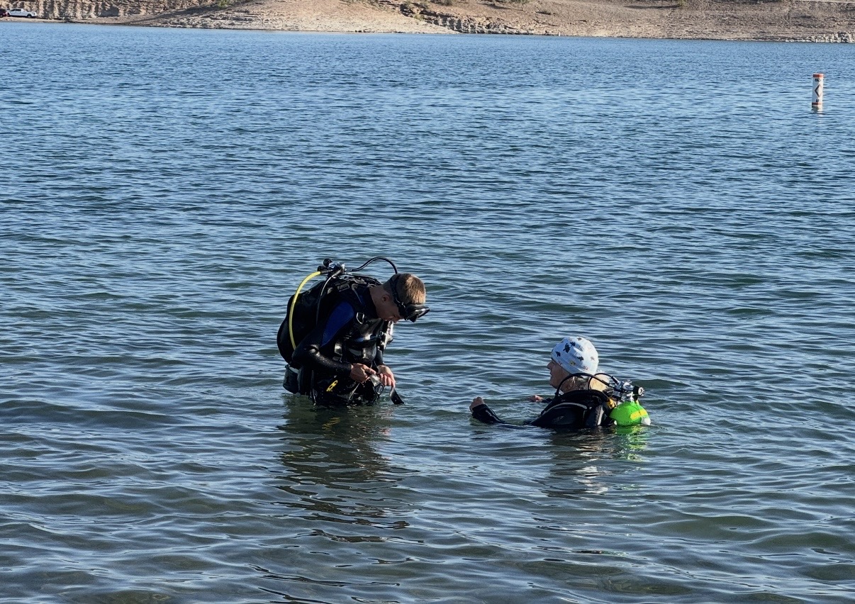 Two divers doing a pre-dive gear check at the surface while scuba diving Lake Pleasant, Arizona