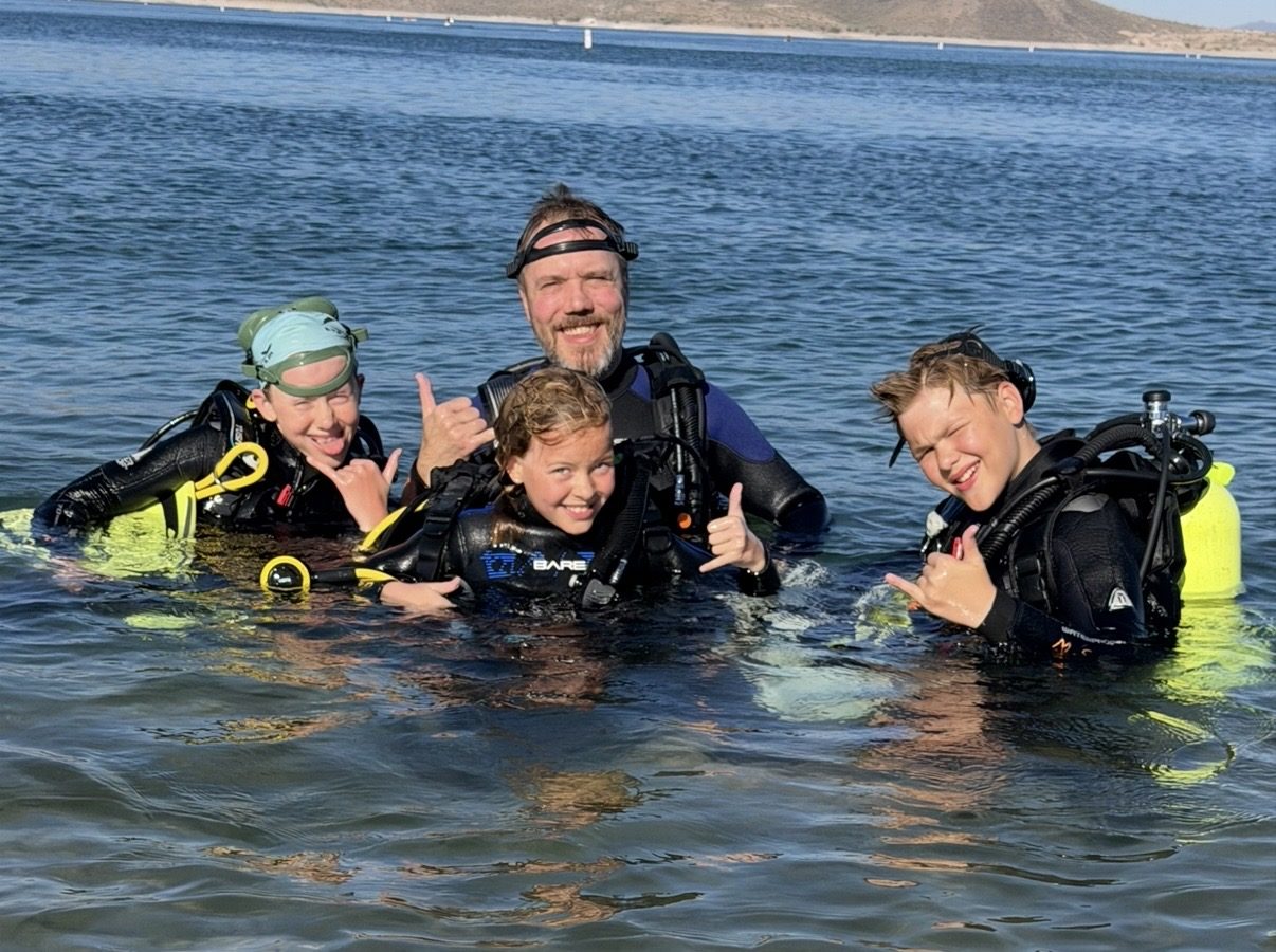 Dive Arizona instructor and three young scuba students smiling in an Arizona lake