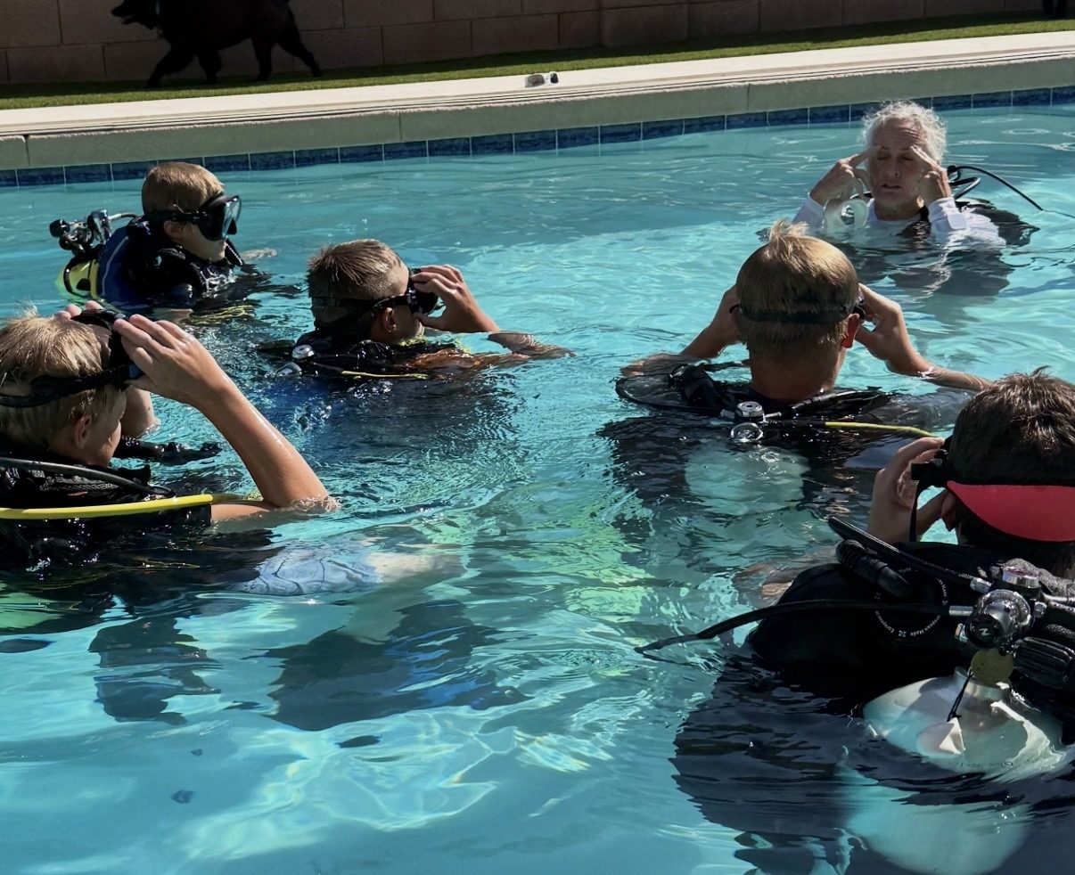 Group of kids in scuba gear learning mask skills with a Dive Arizona instructor in the pool