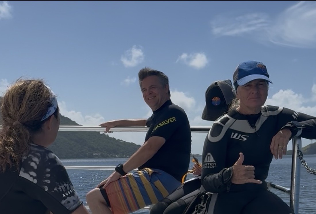 Three Dive Arizona divers relaxing on the boat rail between dives on a group trip