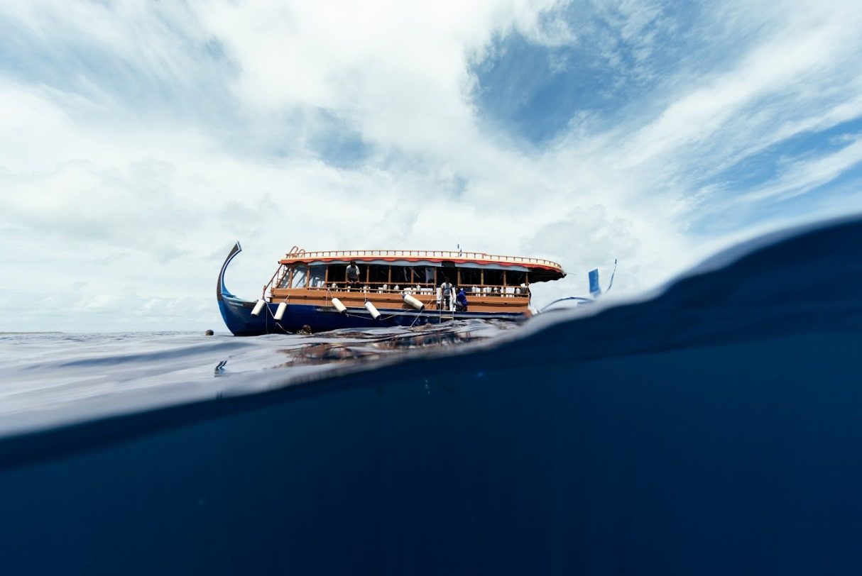 A traditional Maldivian dhoni dive boat on the water