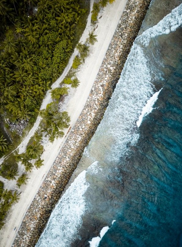 Aerial view of the Fuvahmulah coastline, reef and palm-lined shore
