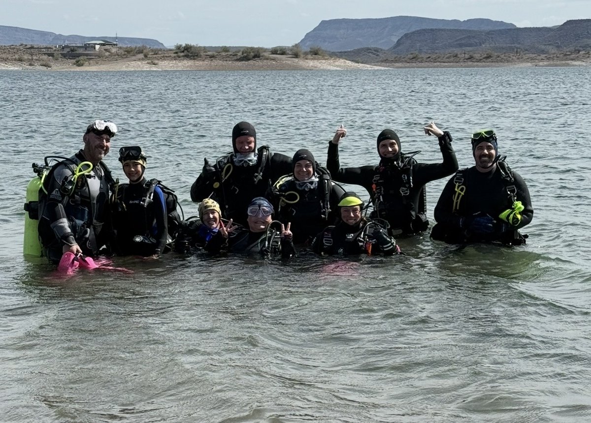 Group of newly certified scuba divers smiling in the water after a dive at an Arizona lake