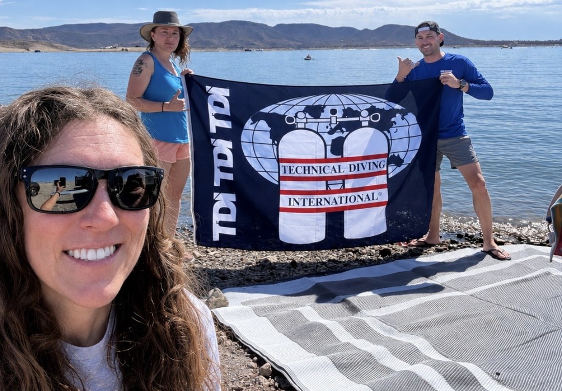 Dive Arizona divers holding a TDI, Technical Diving International, flag on a lake trip