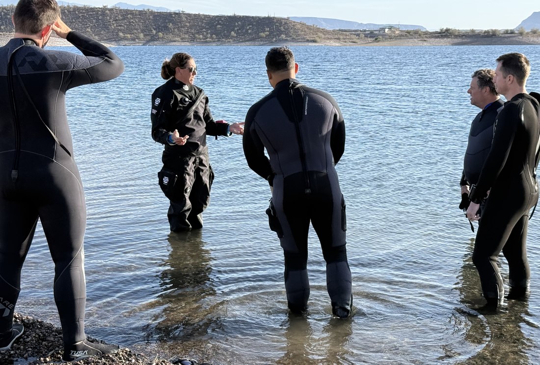 Dive Arizona instructor briefing a group of divers in the shallows before a specialty dive