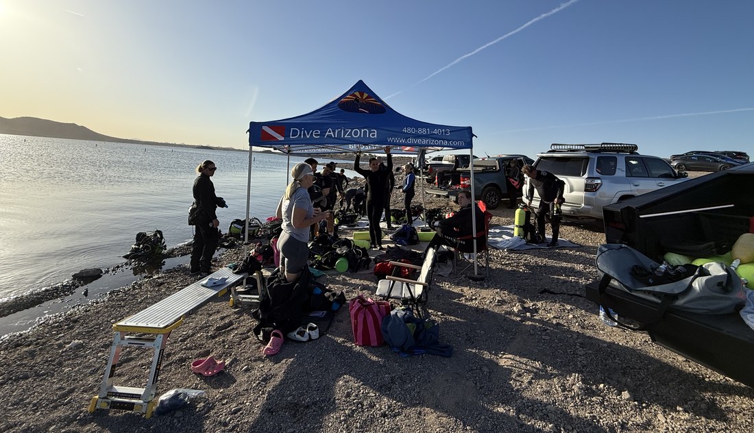 Dive Arizona divers staging gear at the Dive Arizona tent before a lake dive toward Master Diver requirements