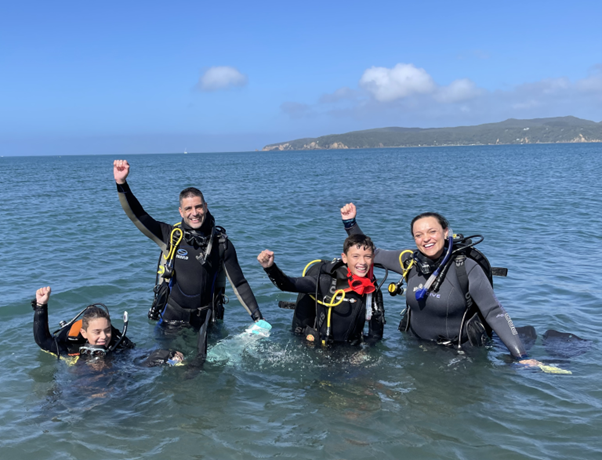 Cold-water diver exploring kelp forest in New Zealand