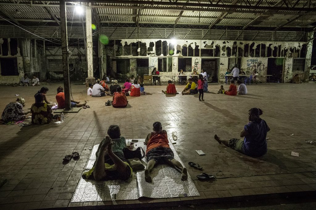 People play Bingo in the abandoned building of a Tea Shop in Arijejen District. Bingo is one of the most popular betting games in the country and many Nauruan people spend their evenings and weekends playing and trying to make some money. 90% of the population is unemployed. Image by Vlad Sokhin