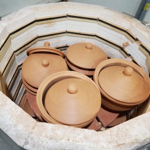 Pots and lids fresh out of firing in a kiln