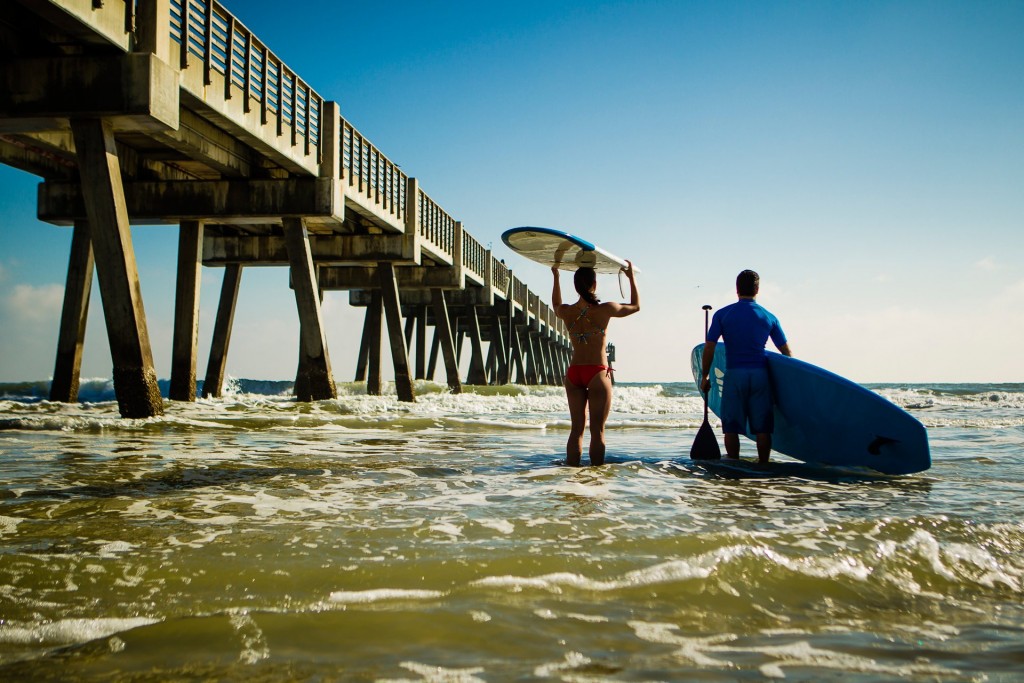 Couple ready to surf and paddleboard in Jacksonville Beach credit Ryan Ketterman Couple ready to surf and paddleboard in Jacksonville Beach credit Ryan Ketterman